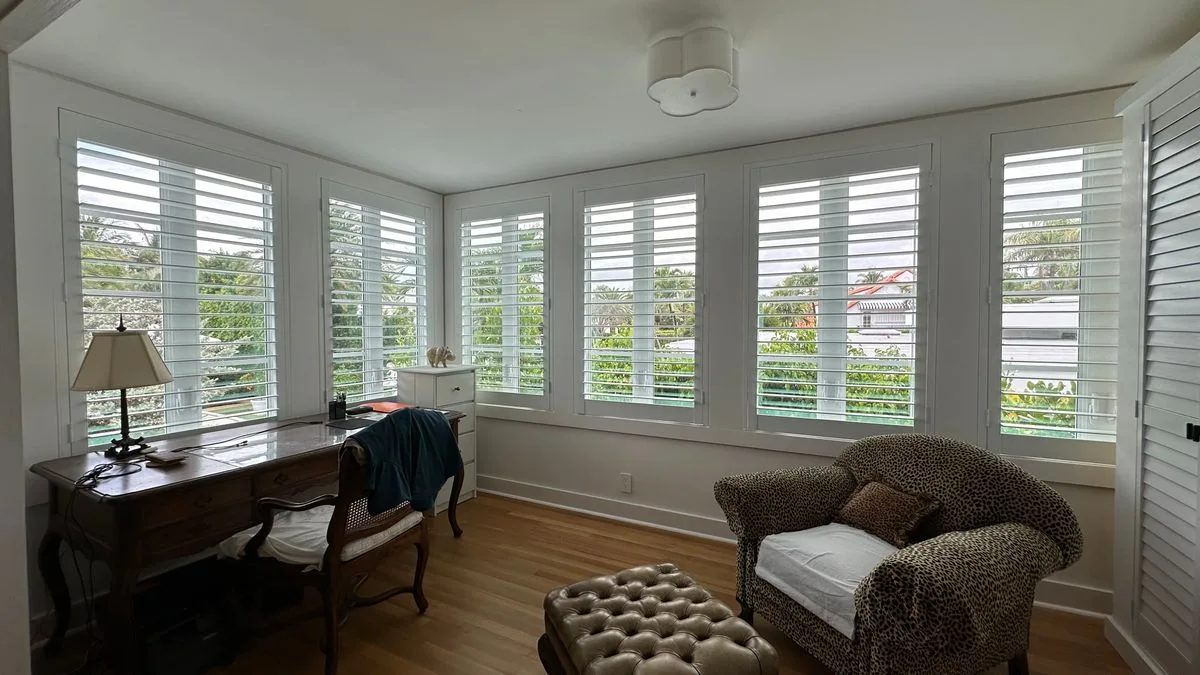 Whole-home white plantation shutter installation across open-plan living and dining rooms in a regional NSW home listed for sale